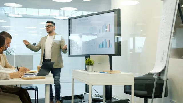 Professional presenting sales data in modern office meeting. Sales development versus account management