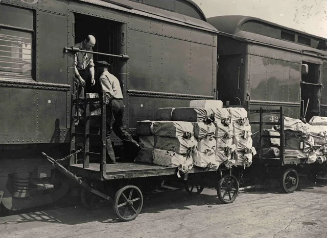 Description : This is an image of sacks of mail being loaded onto a Railway Post Office (RPO) car. The metal RPO mail exchange arm can clearly be seen on the car door. Creator/Photographer : Unidentified photographer Medium : Black and white photographic print Culture : American Geography : USA Date. Checking sales-sequence delivery before and after launch